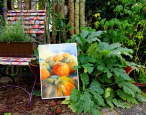 Im Garten steht ein Aquarell das Kürbisse zeigt
